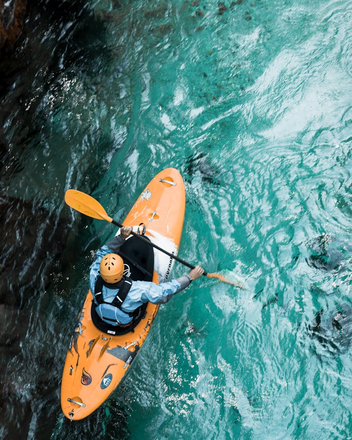 creative-01 A kayaker paddles through clear turquoise waters, showcasing adventure sports in Croatia.